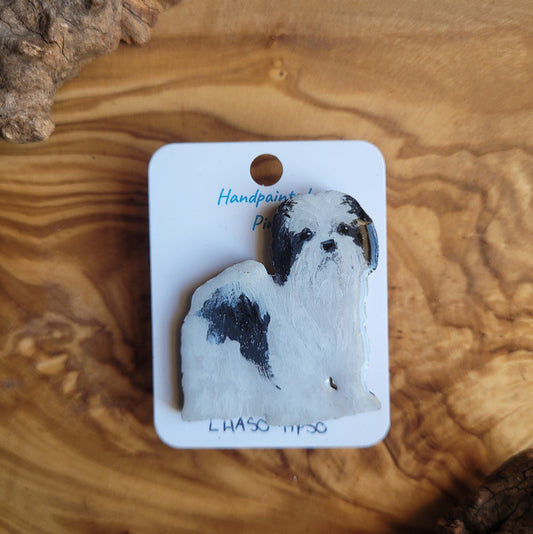 Hand-painted dog pin on a wooden surface
