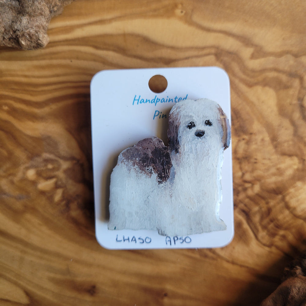 Handpainted dog pin on a wooden surface