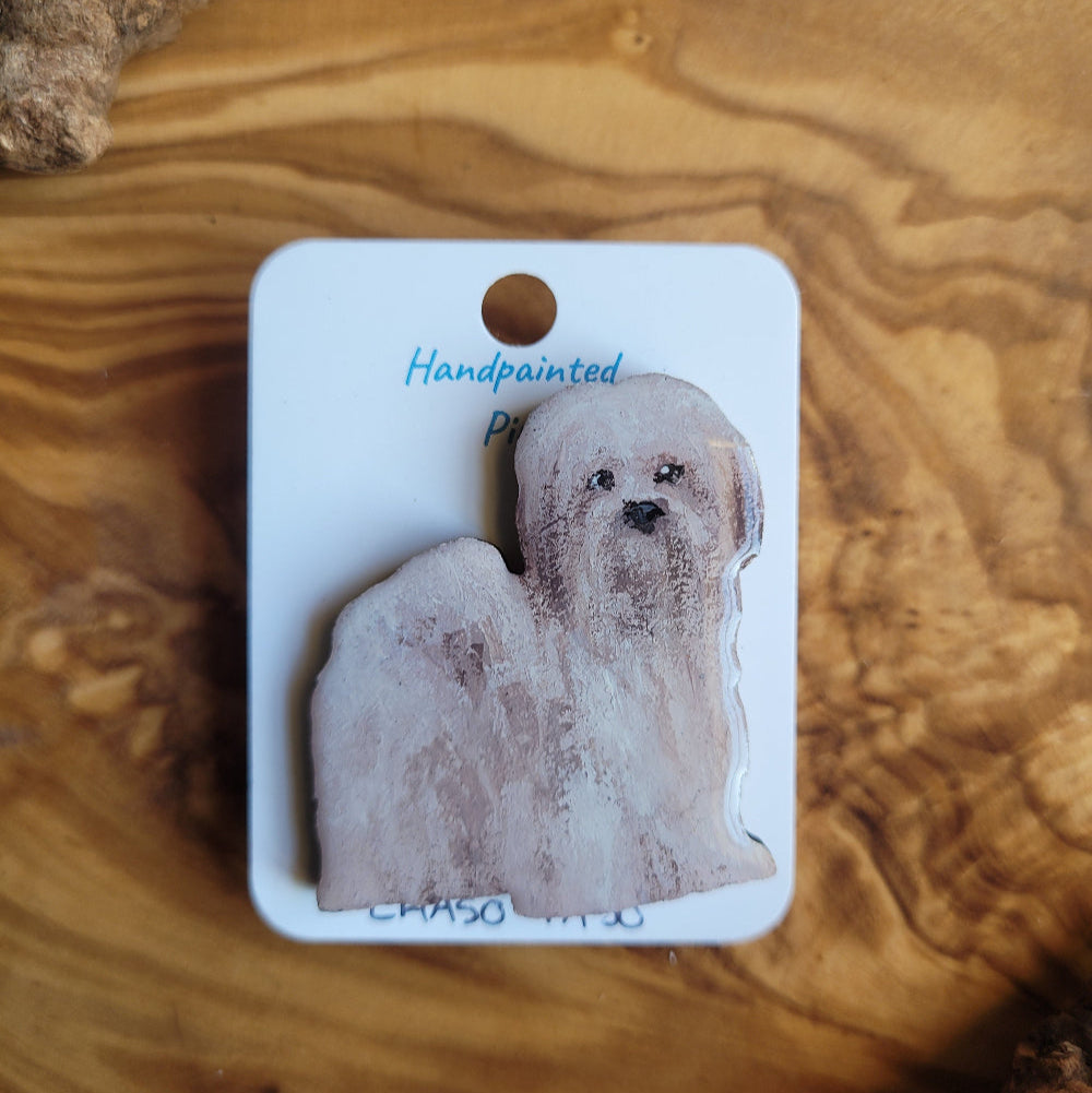 Handpainted dog pin on a wooden surface