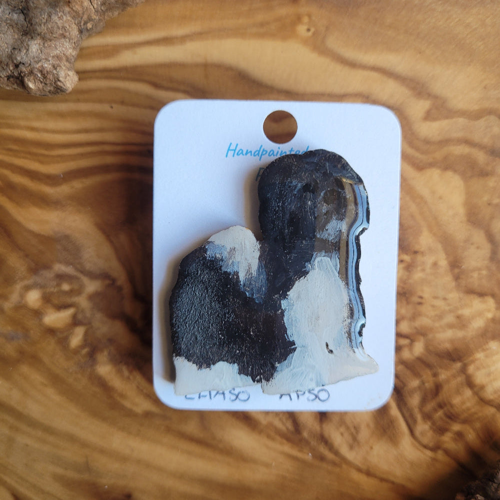 Handpainted Lhaso Apso Dog pin displayed on white card on wooden background