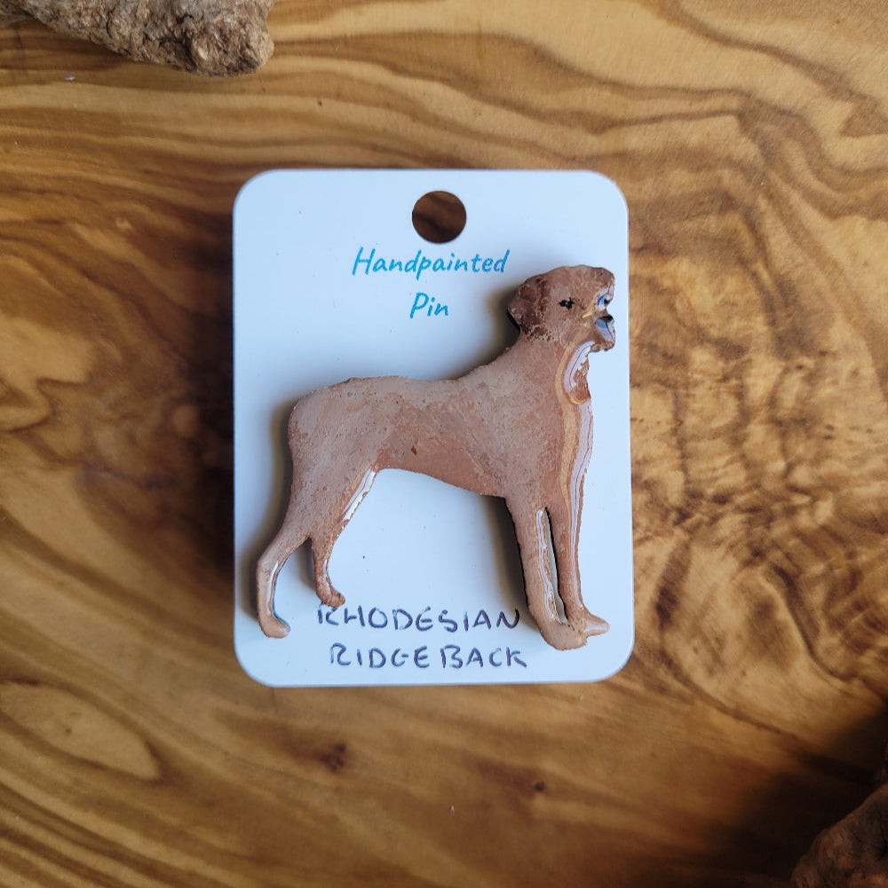 Handpainted Rhodesian Ridgeback pin on a wooden surface