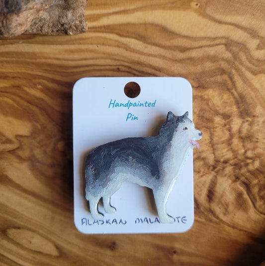 Handpainted Alaskan Malamute pin on a wooden surface