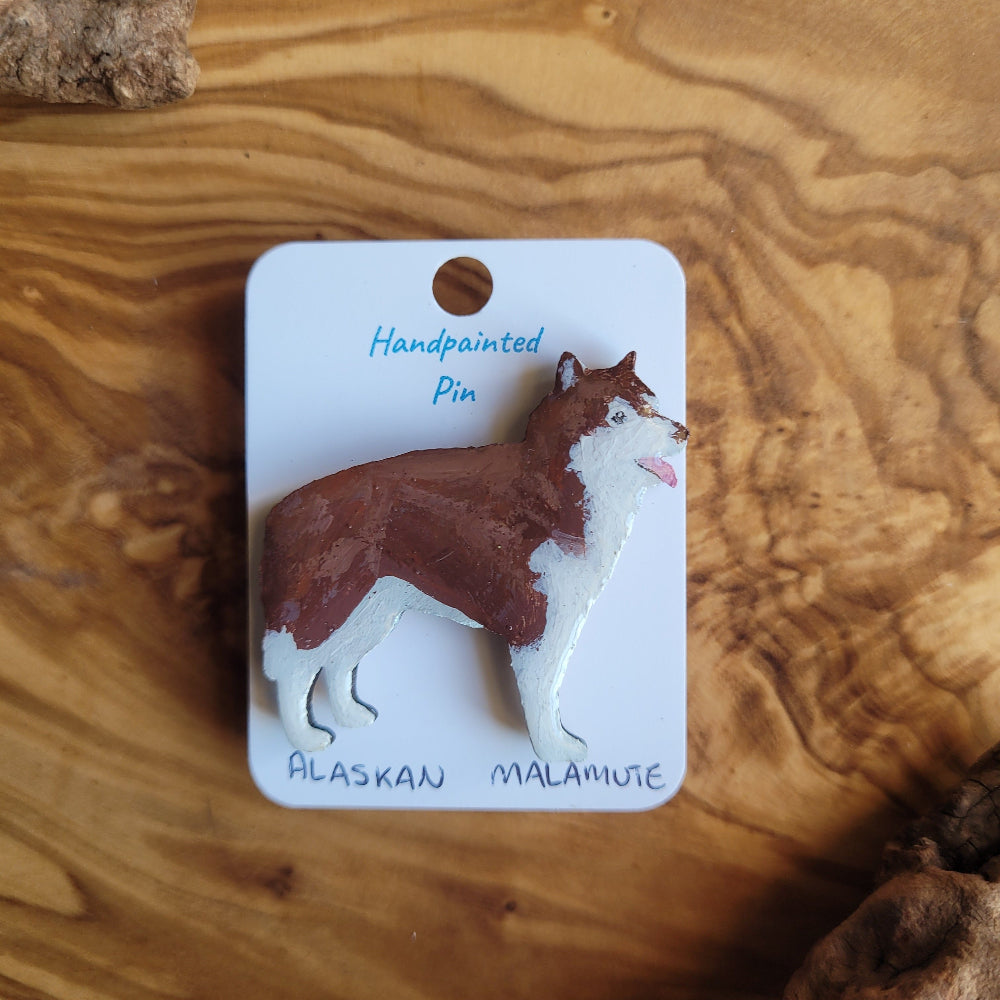 Handpainted Alaskan Malamute pin on a wooden surface