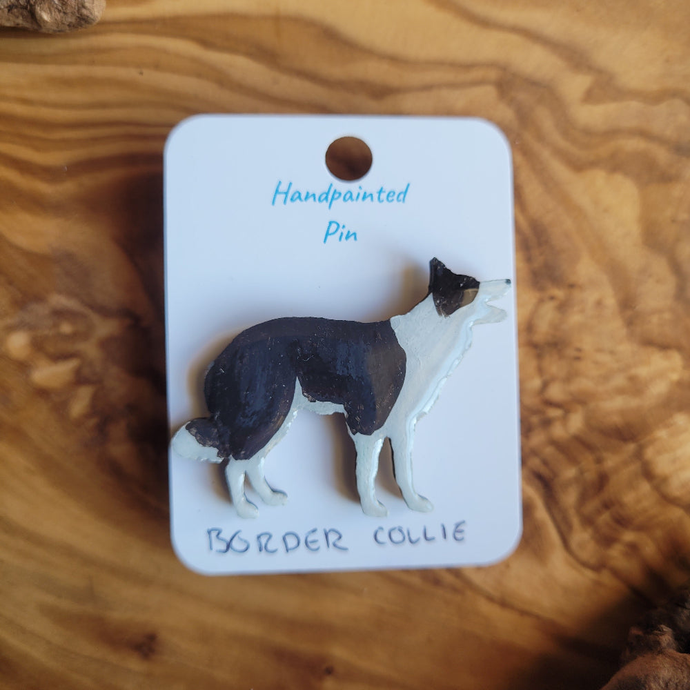 Handpainted Border Collie pin on a wooden surface