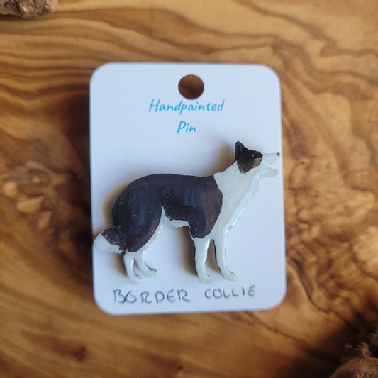 Handpainted Border Collie pin on a wooden surface