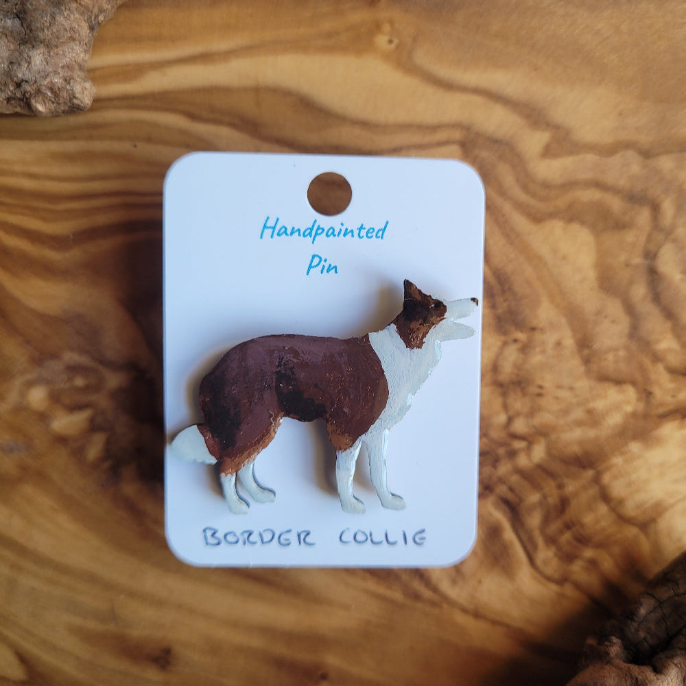 Handpainted Bozder Collie pin on a wooden surface