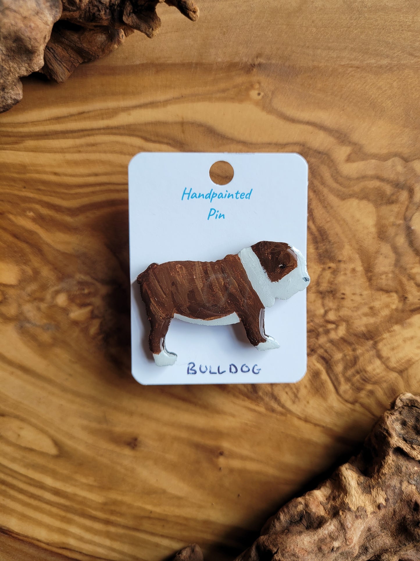 Hand-painted wooden dog pin of a brindle and white bulldog