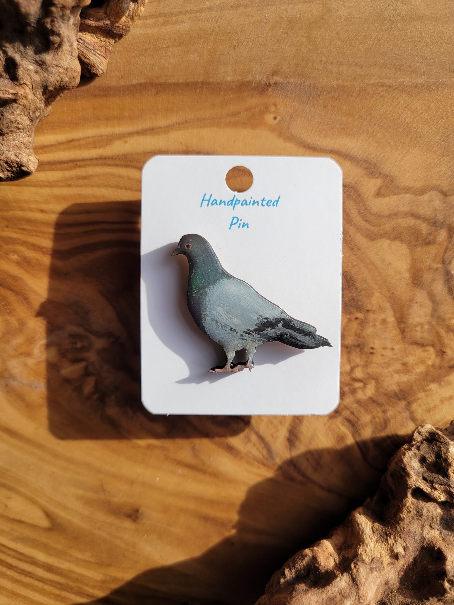 hand-painted plump city pigeon with shimmering irredescent feathers, wooden pigeon shaped pin badge