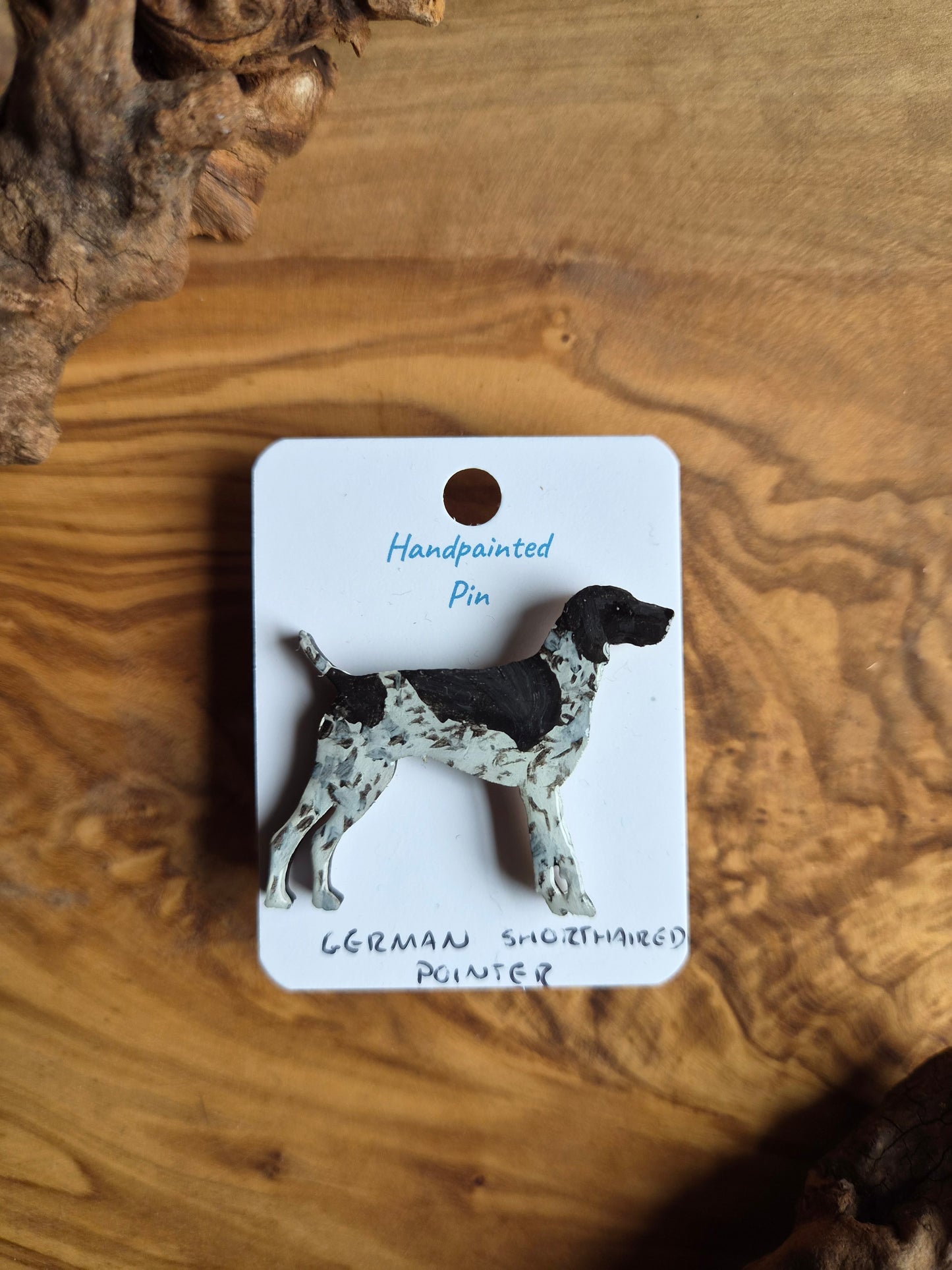 Hand-painted wooden dog pin of a German Shorthaired Pointer, white speckled with a couple of black patches over the head and body