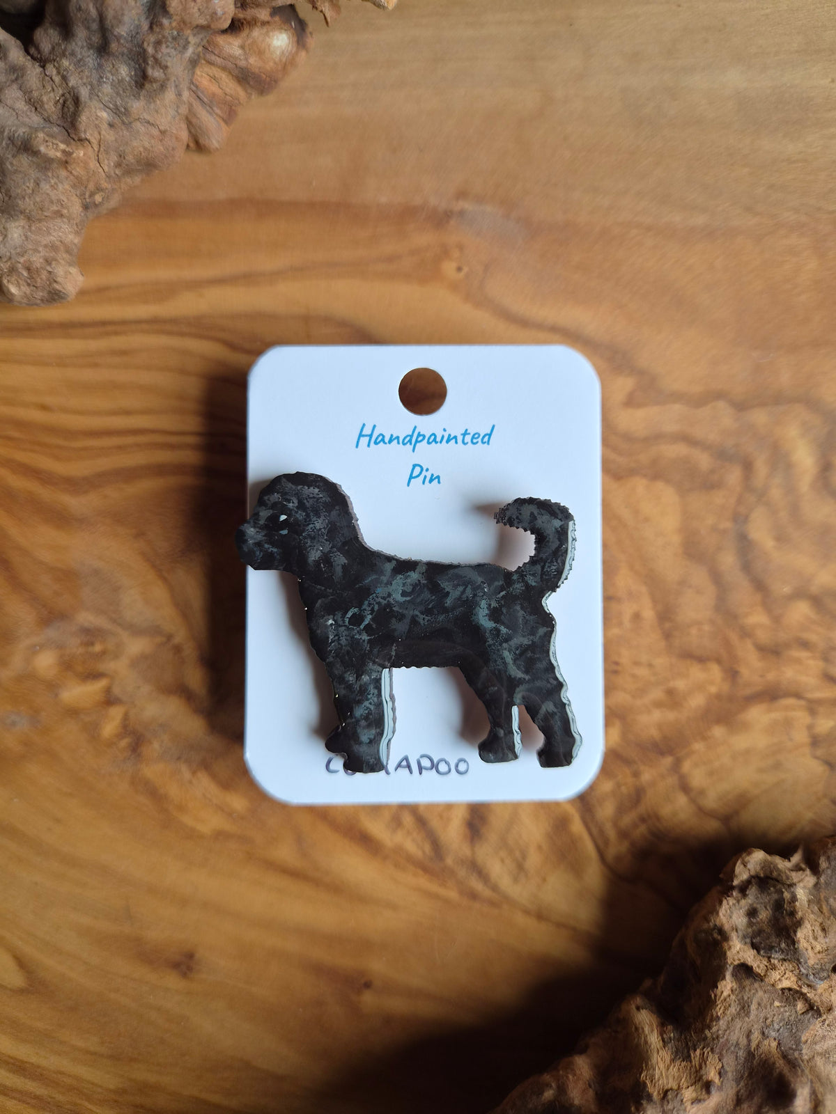 Hand-painted wooden pin badge of a black coloured cockapoo