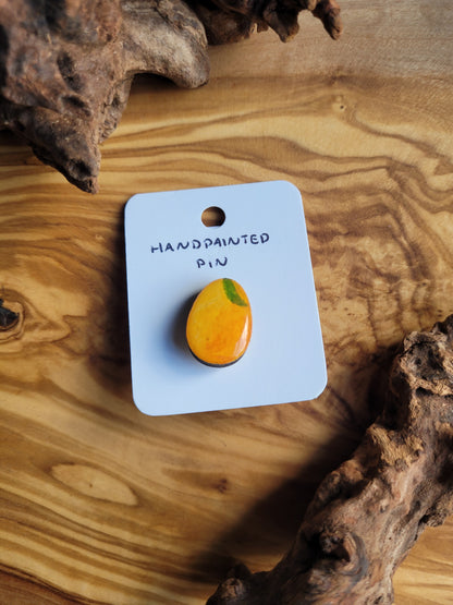 Hand-painted wooden Easter Egg shaped pin badge painted like a lemon with a little leaf