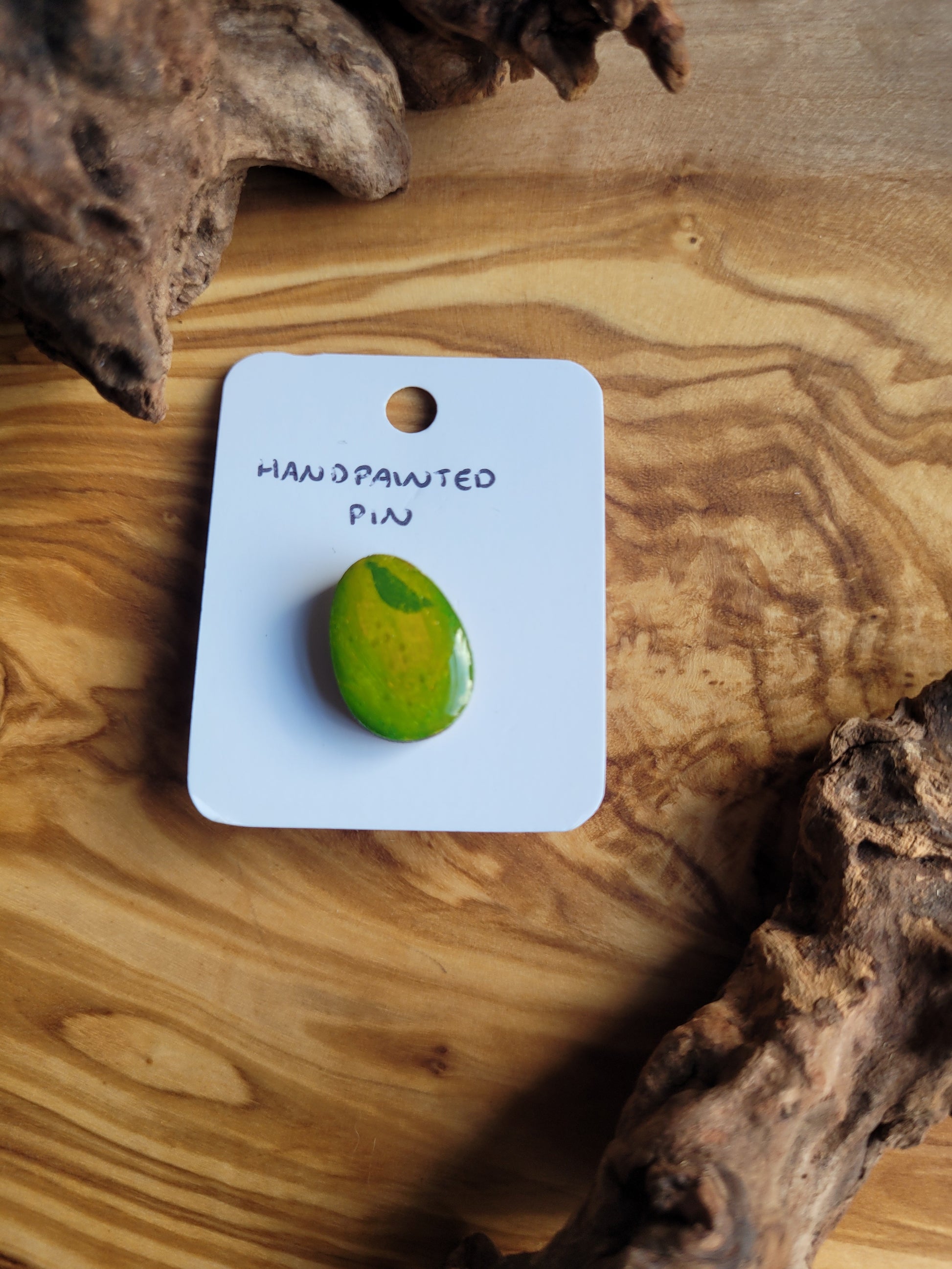 Hand-painted wooden Easter Egg shaped pin badge painted like a green lime fruit with a little leaf