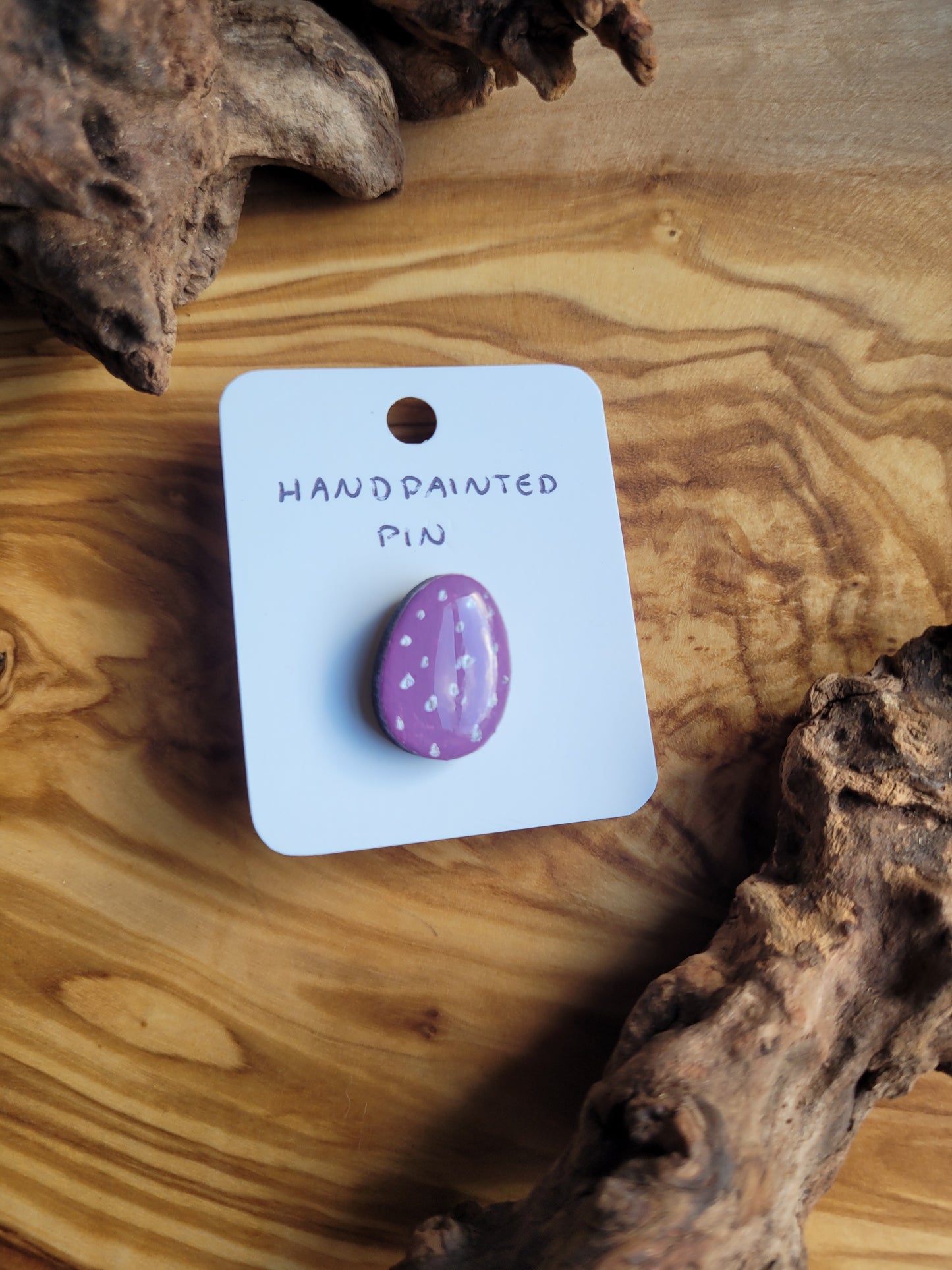 Hand-painted wooden Easter Egg shaped pin badge with silver dots on a purple background