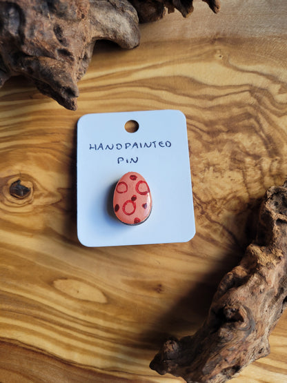 Hand-painted wooden Easter Egg shaped pin badge with dots and circles of variying pink tones