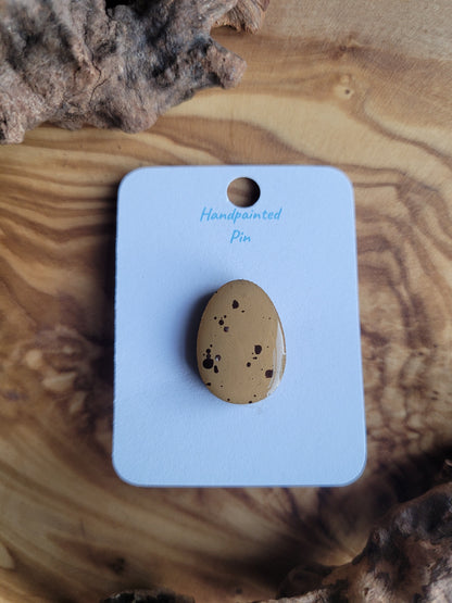 Hand-painted wooden Easter Egg shaped pin badge with mini egg splodges on a deep yellow/tan egg