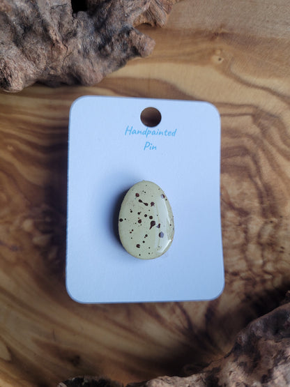 Hand-painted wooden Easter Egg shaped pin badge with brown dots on a pale yellow background like a mini egg