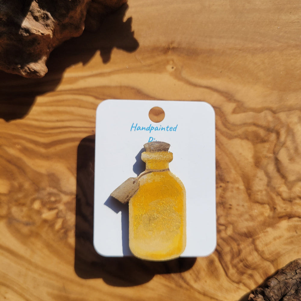 yellow-gold handpainted potion bottle shaped pin