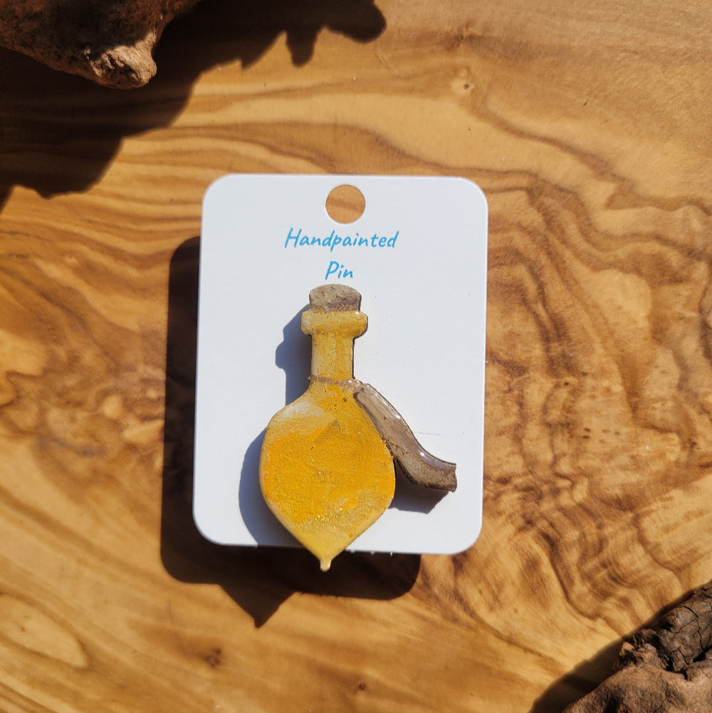 yellow-gold handpainted potion bottle shaped pin