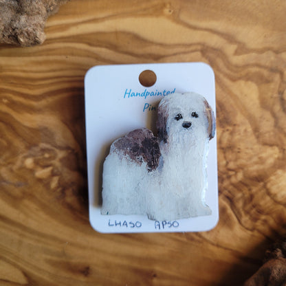 Handpainted dog pin on a wooden surface
