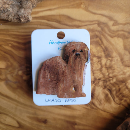 Handpainted wooden lhaso apso dog pin on a white card with 'Handpainted pin' text, placed on a wooden surface.