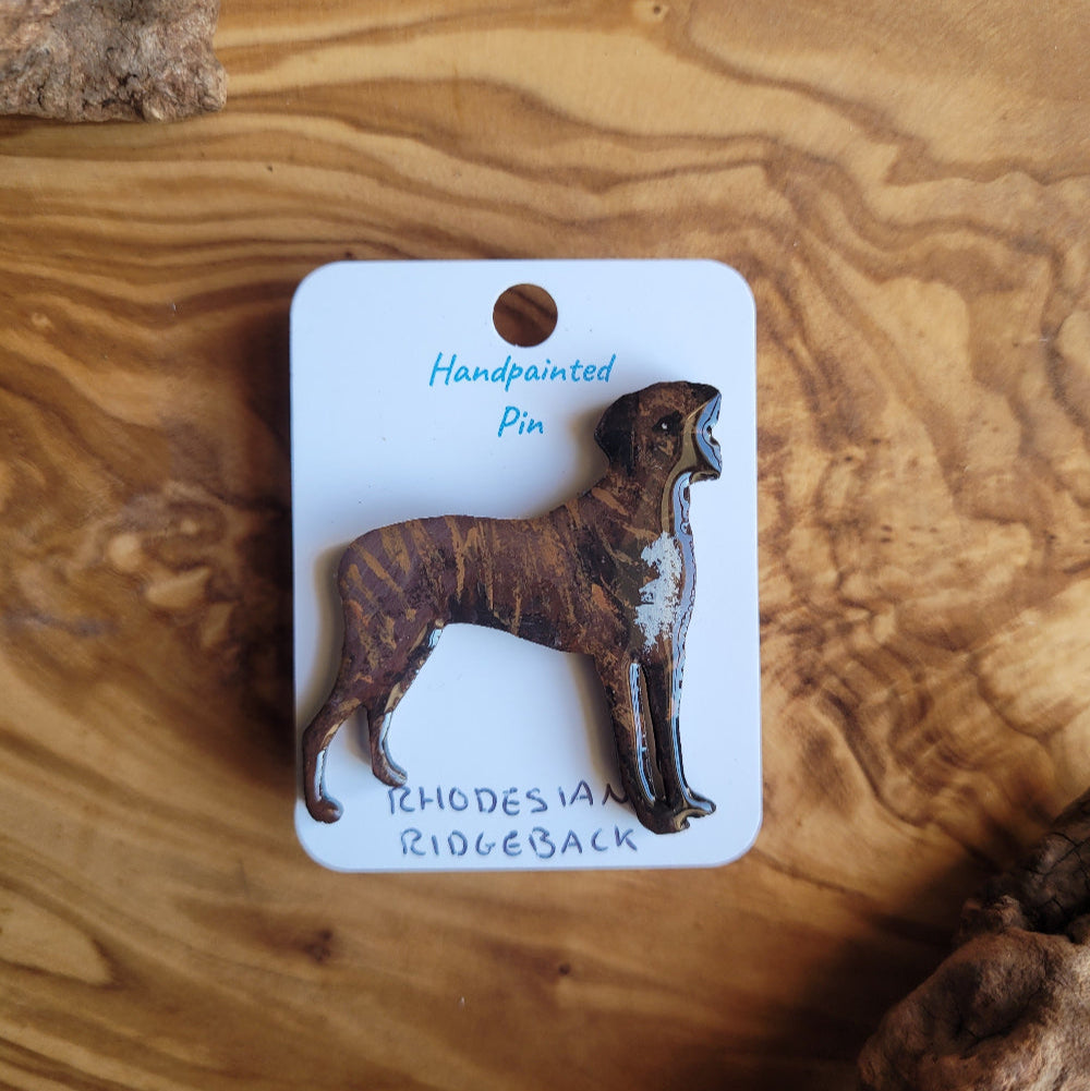 Handpainted Rhodesian Ridgeback pin on a wooden surface