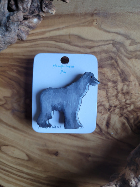 Silver-grey hand-painted Afghan Hound dog pin on a wooden base