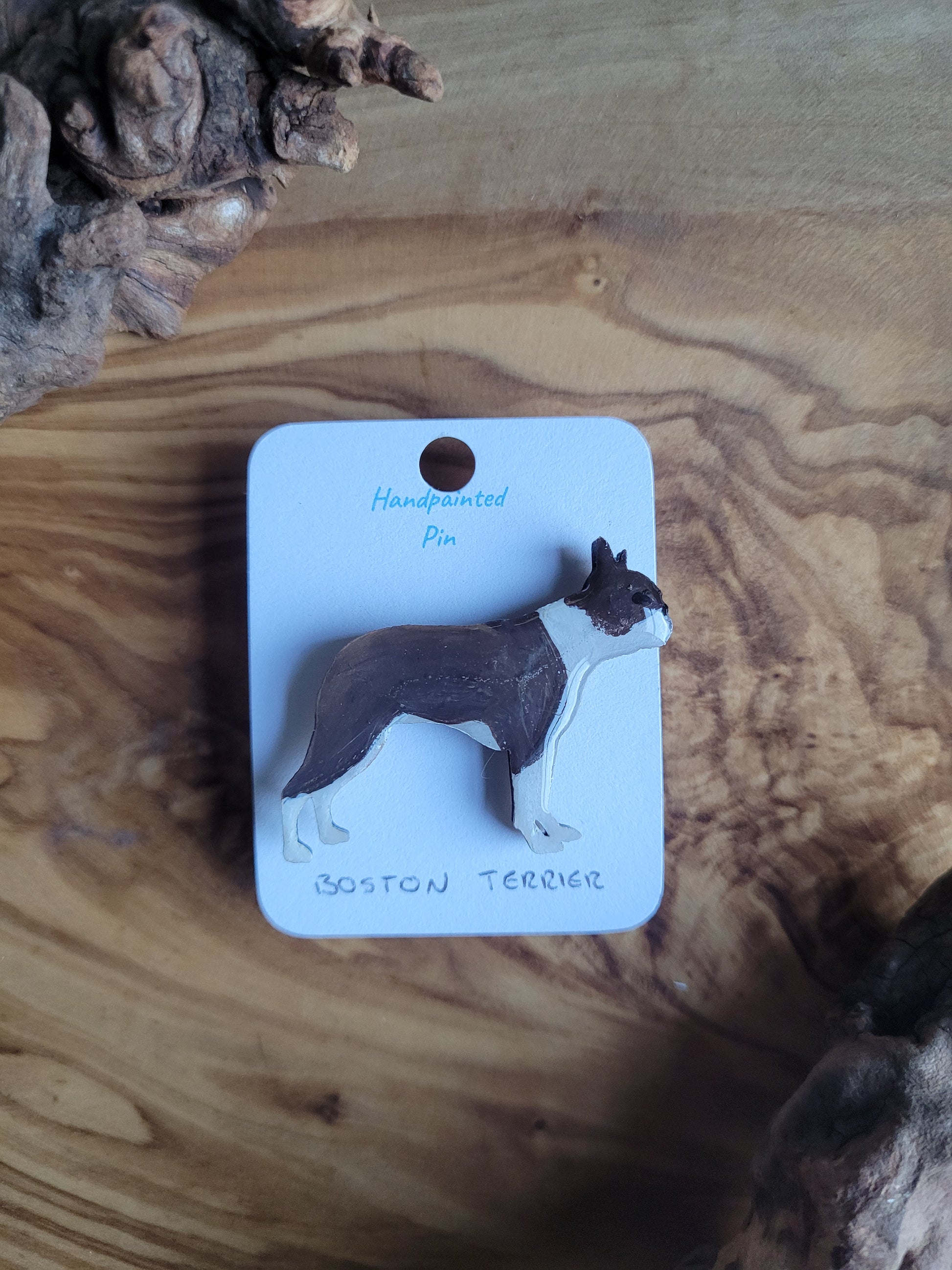 Hand-painted Wooden dog pin badge of a seal and white coloured Boston Terrier 