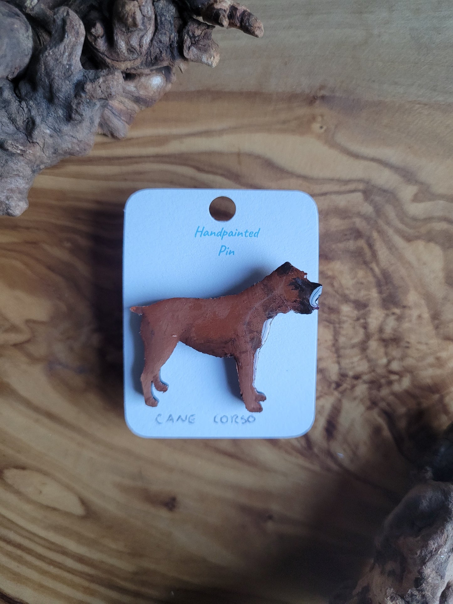 Hand-painted wooden pin badge of a red coloured Cane Corso dog.