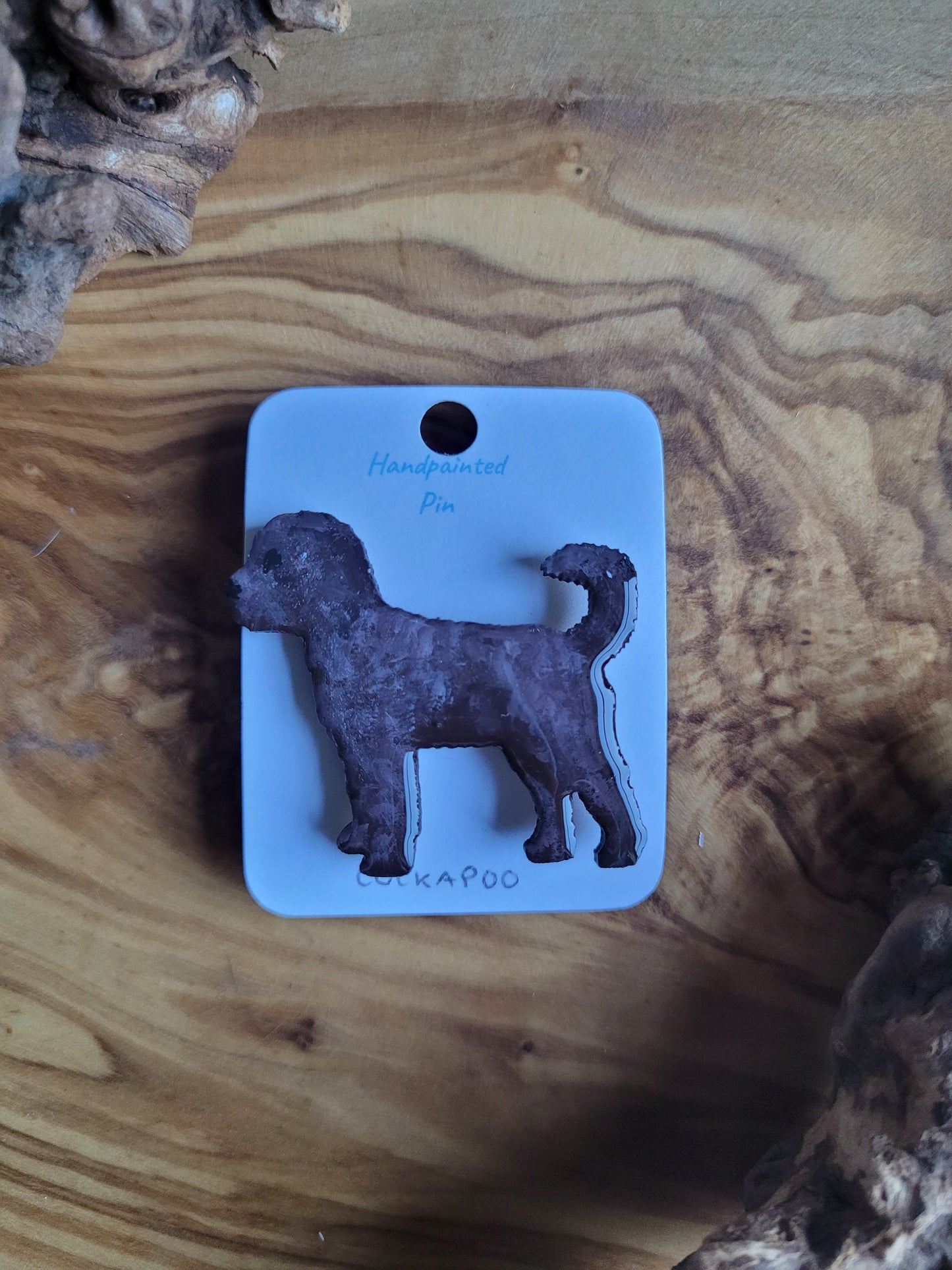 Hand-painted wooden dog pin badge of a chocolate coloured Cockapoo