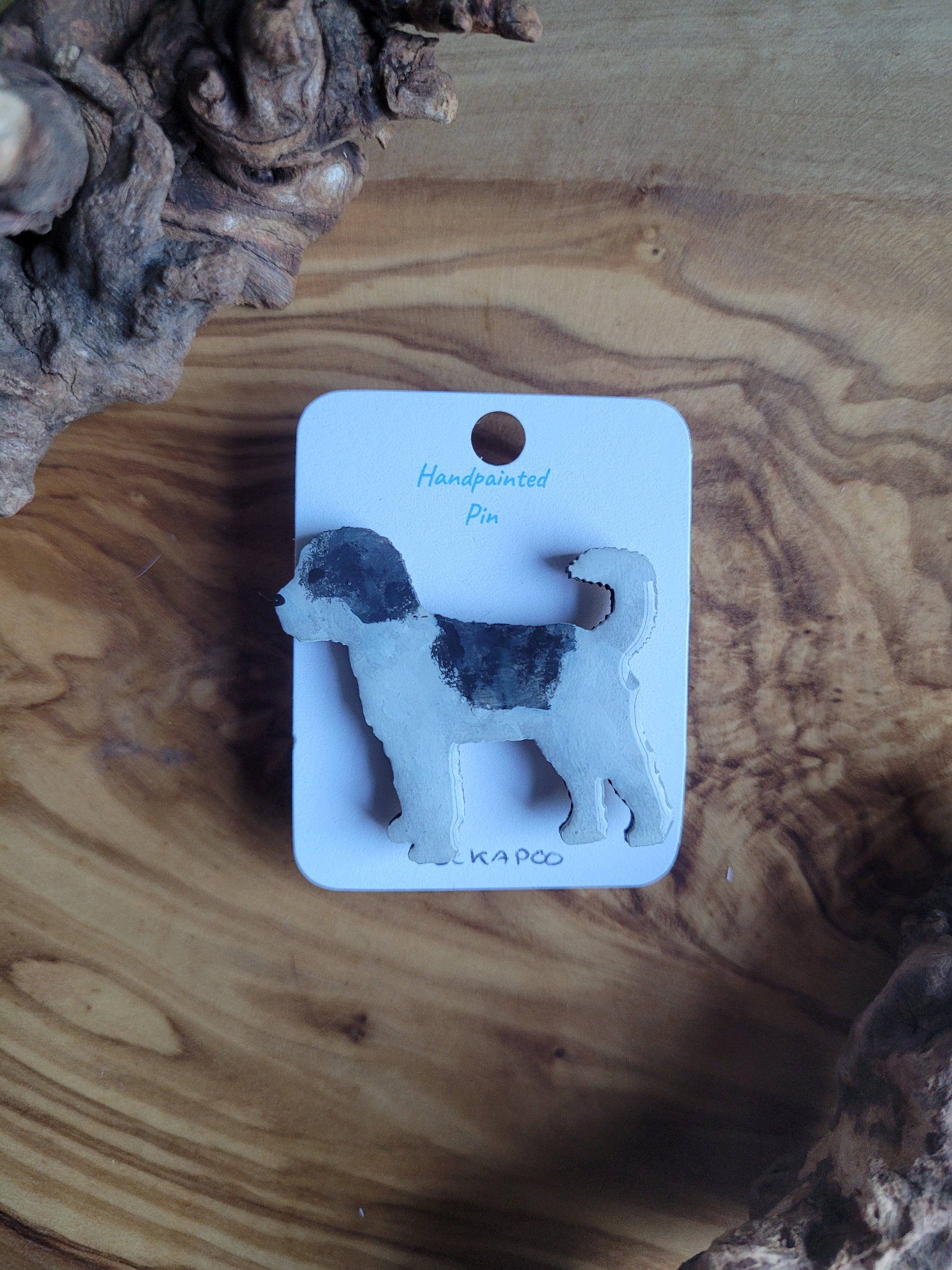 Hand-painted wooden dog pin badge of a white with Black patches colour Cockapoo