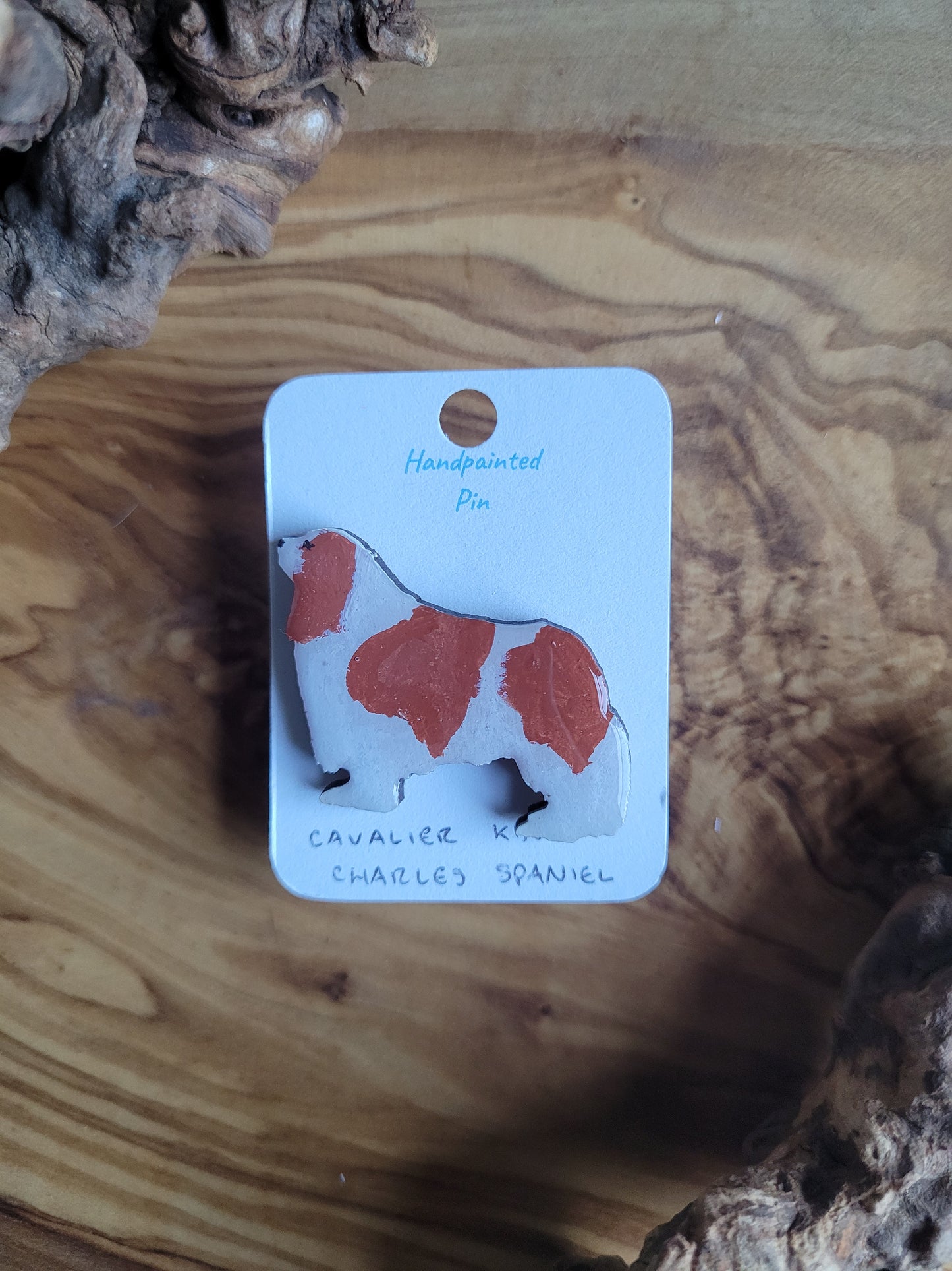 Hand-painted red and white coloured Cavalier King Charles Spaniel wooden pin badge