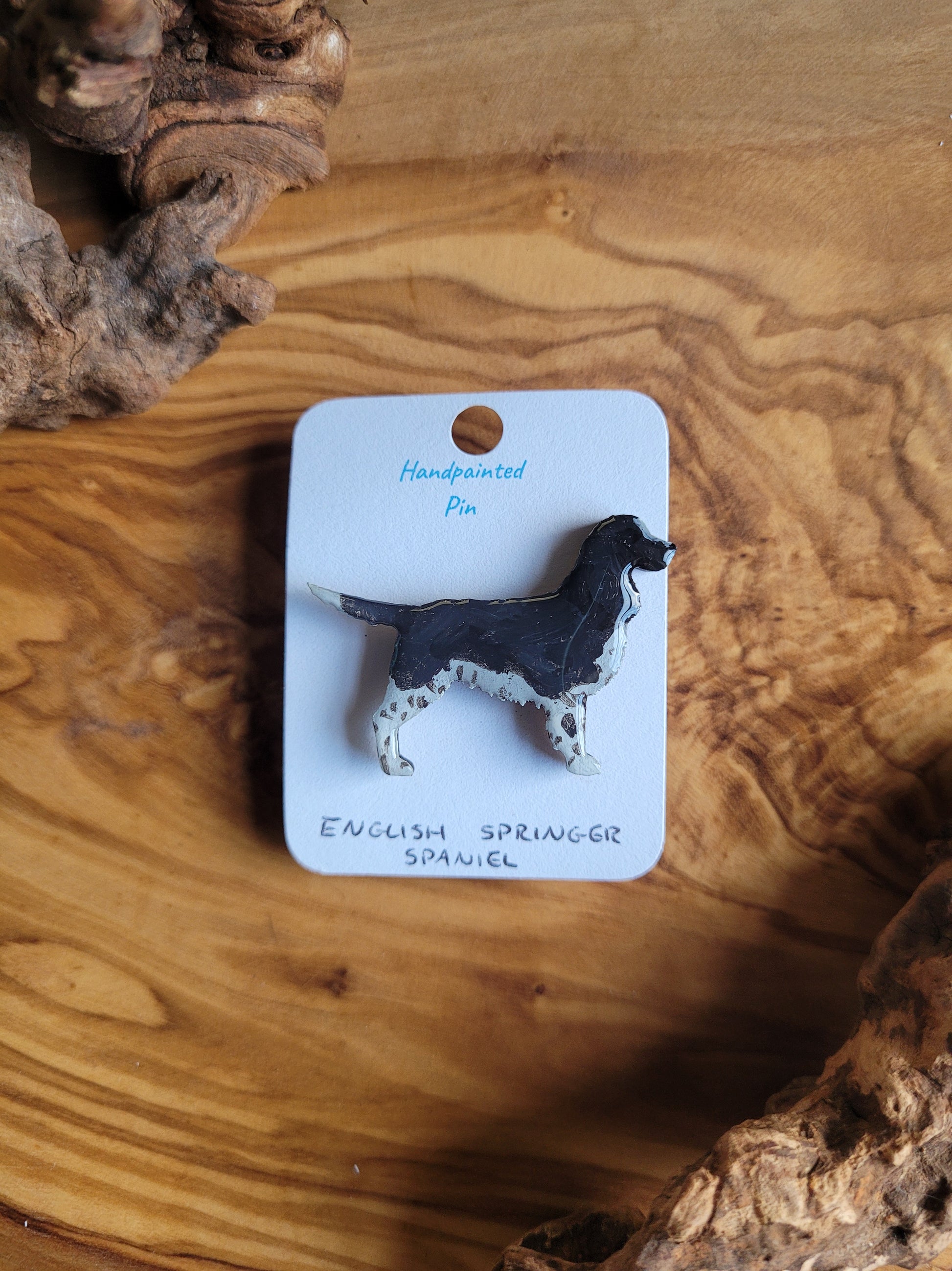 Hand-painted wooden dog pin badge of an English Springer Spaniel, black and white colour