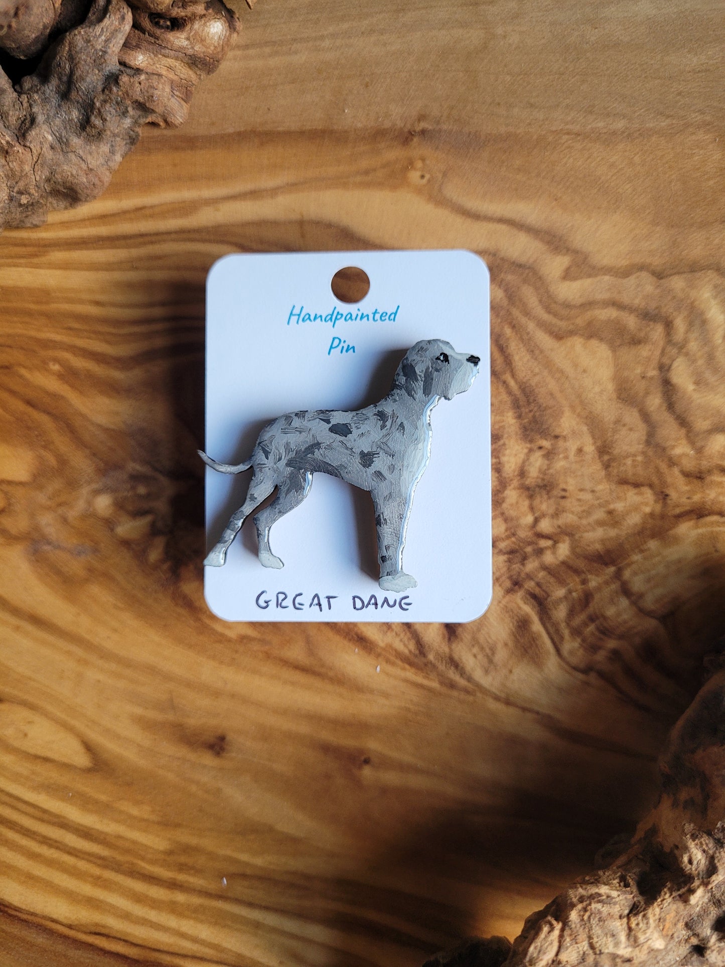 Hand-painted wooden pin badge of a blue merle Great Dane