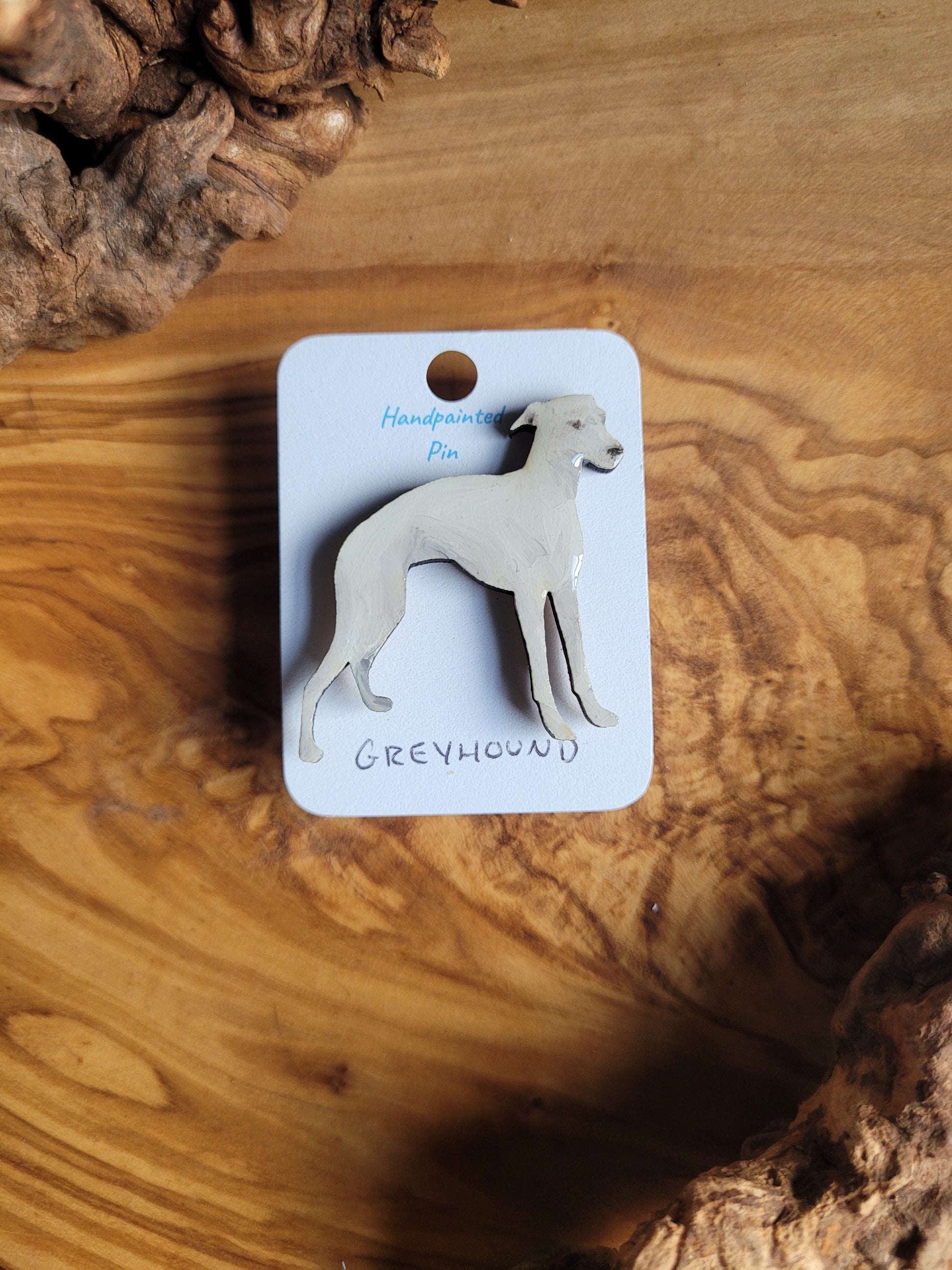 Hand-painted Greyhound pin badge, painted onto wood. White coloured greyhound