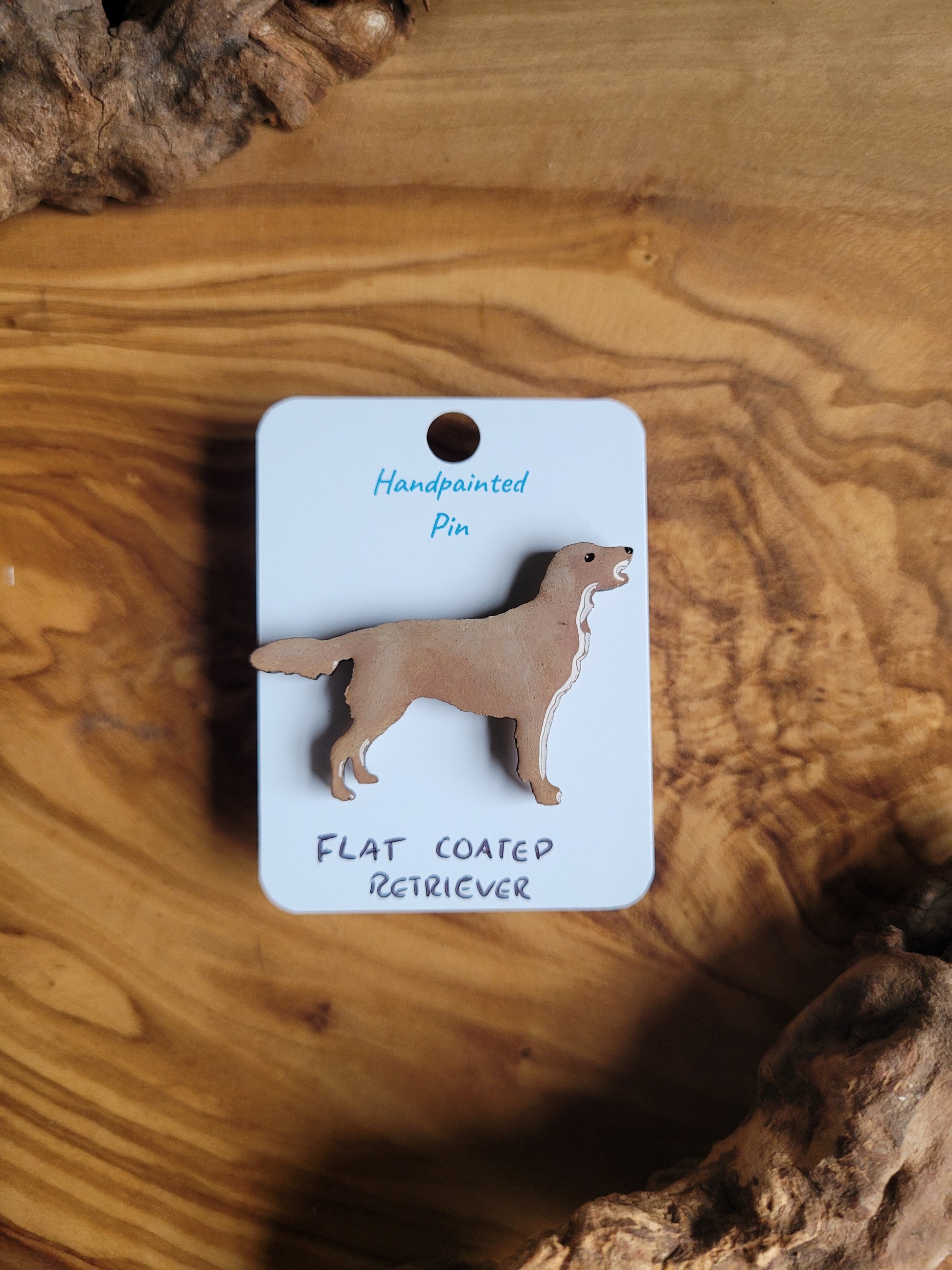 Golden hand-painted wooden dog pin badge of the Flat Coated Retriever
