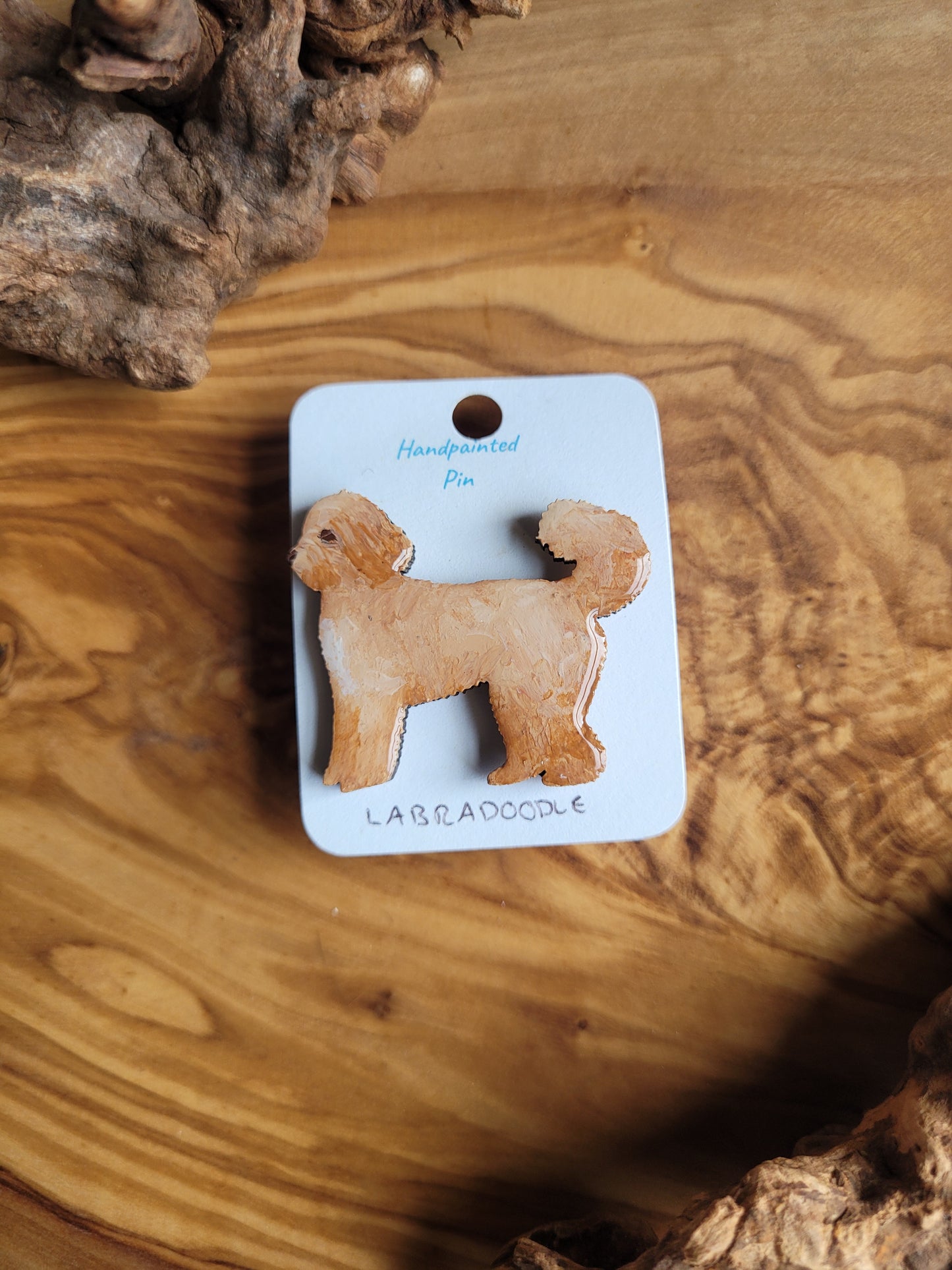 Hand-painted Labdradoodle dog pin badge, painted onto wood and golden coloured with a white chest