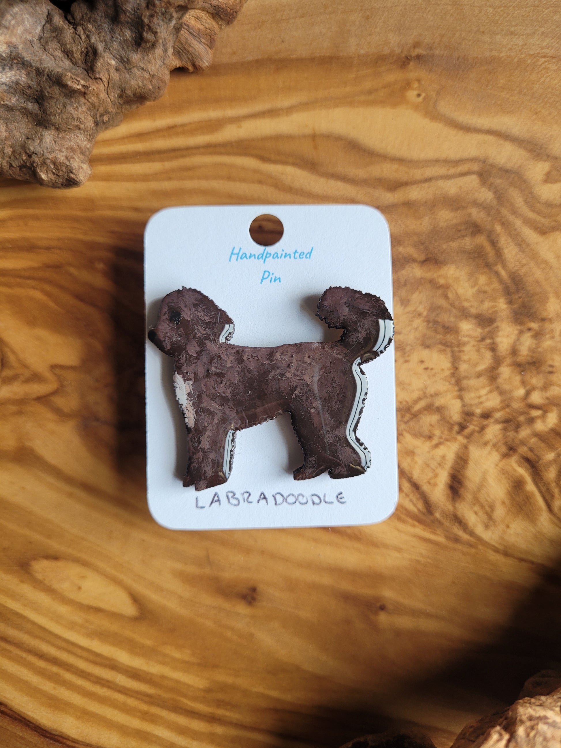 Hand-painted Labdradoodle dog pin badge, painted onto wood and chocolate coloured with a white chest patch