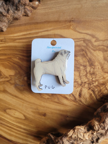 Hand-painted wooden pin badge of a fawn coloured Pug