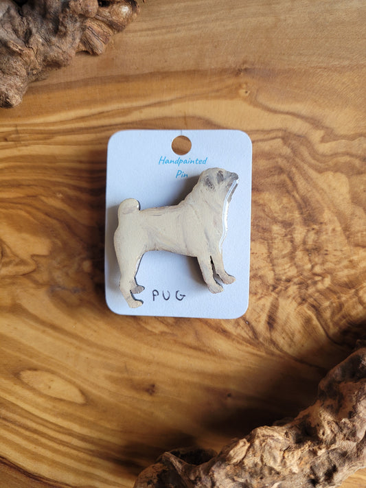 Hand-painted wooden pin badge of a fawn coloured Pug