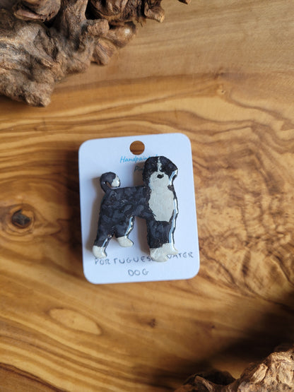 Hand-painted Portuguese Water Dog pin badge, painted onto wood. Black and white colour.