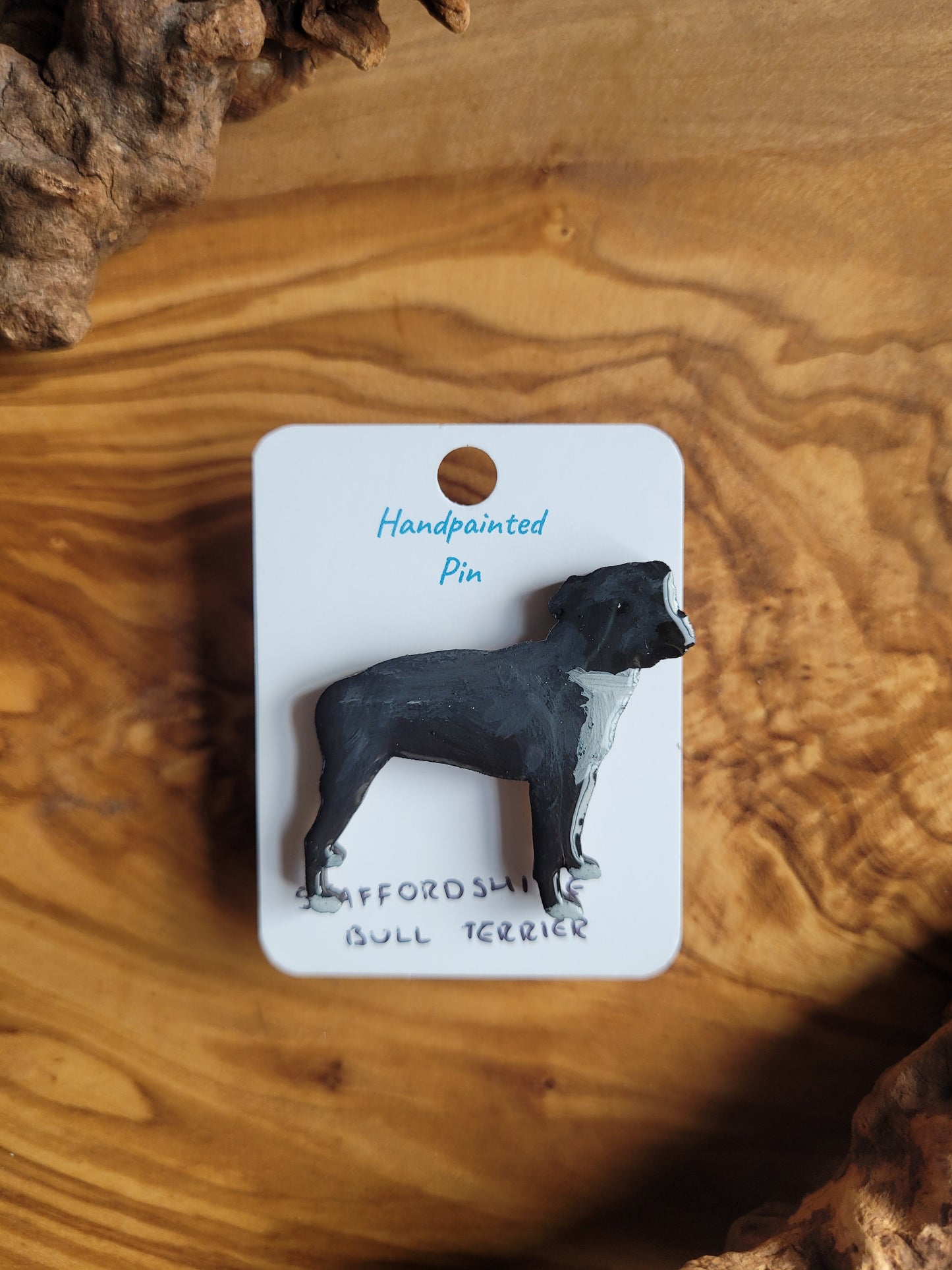 Hand-painted staffordshire bull terrier dog pin badge, painted onto wood. Black and white chest and paws colour