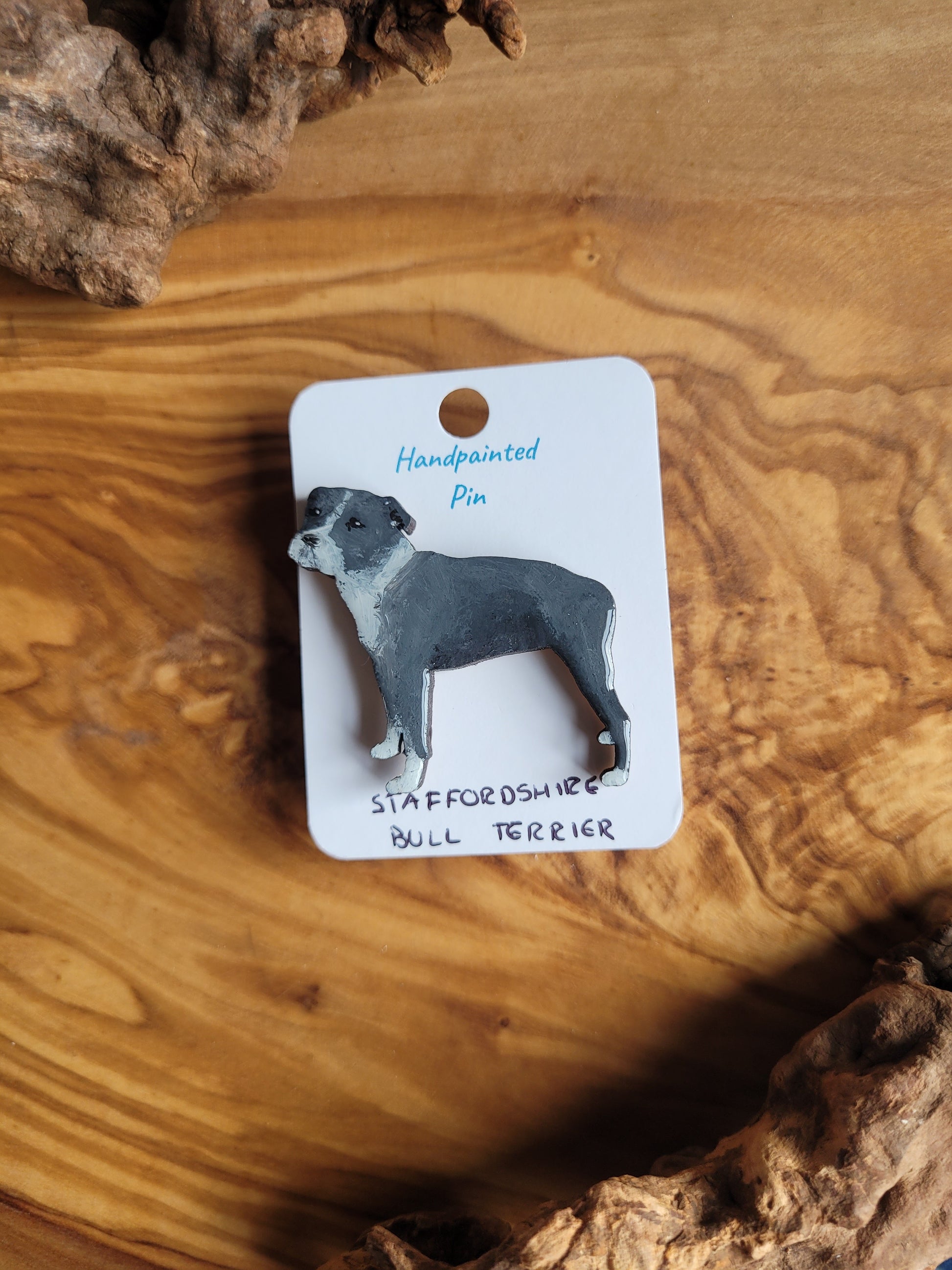 Hand-painted staffordshire bull terrier dog pin badge, painted onto wood. Blue and white colour
