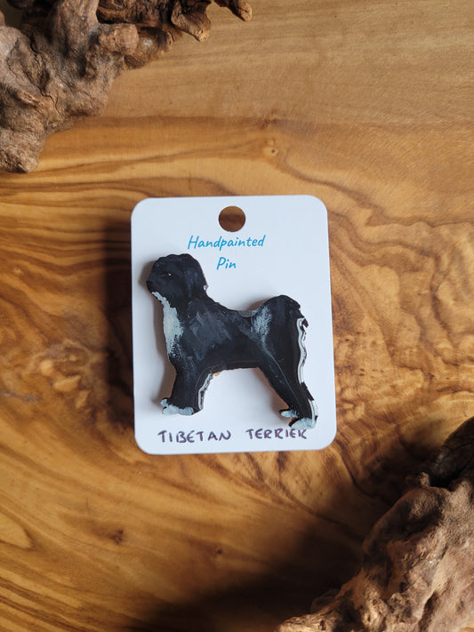 Hand-painted Tibetan terrier wooden dog pin badge. Black with white patch on chest, tail and paws coloured terrier
