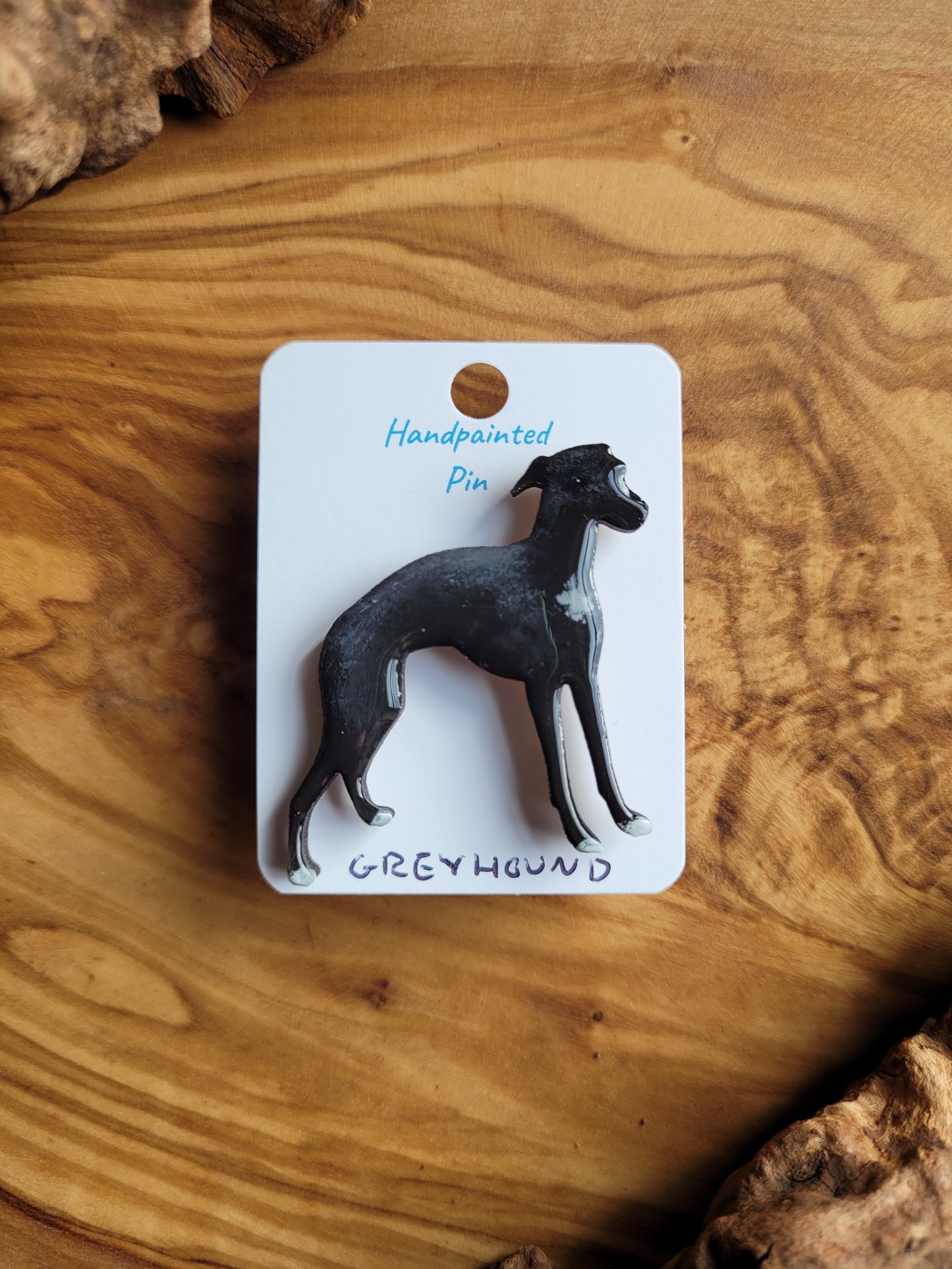 Hand-painted Greyhound pin badge, painted onto wood. Black and white small patch on the chest and paws