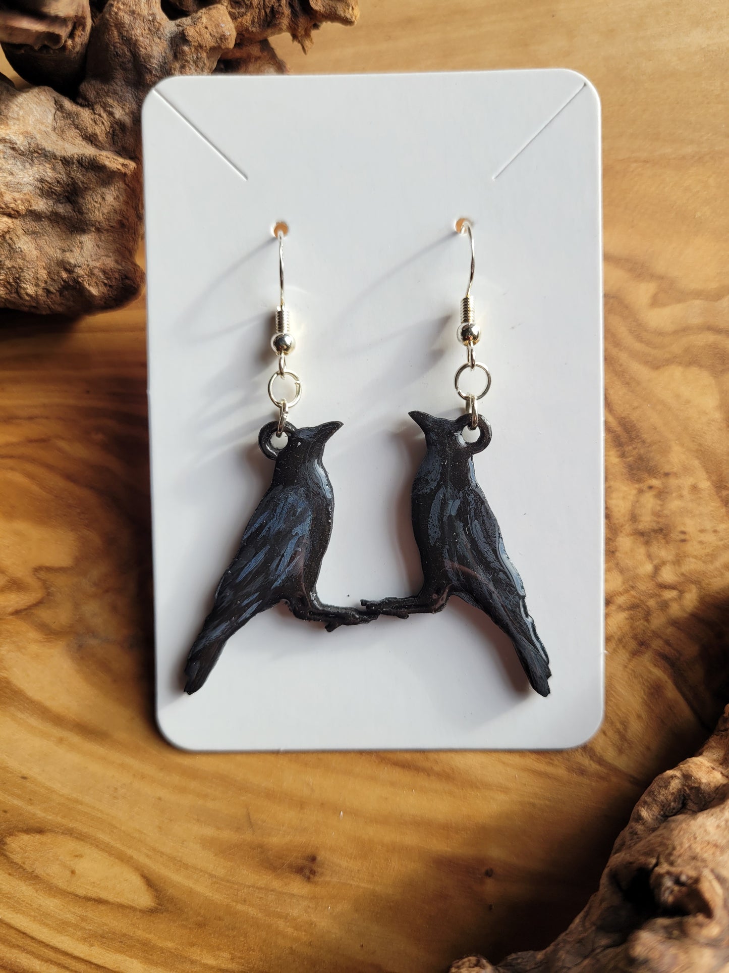 Hand-painted wooden shaped raven earrings on stirling silver hardware