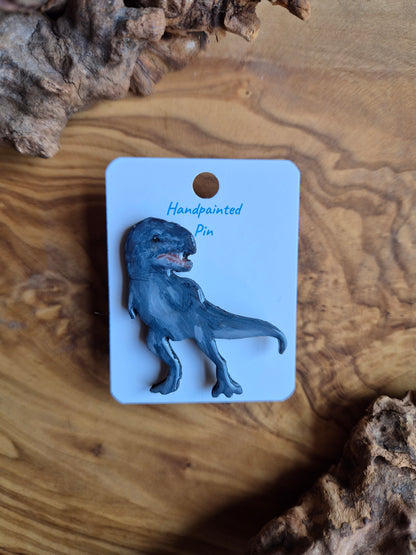 A hand-painted wooden T-Rex dinosaur pin badge of the classic tyranosaurus rex dinosaur