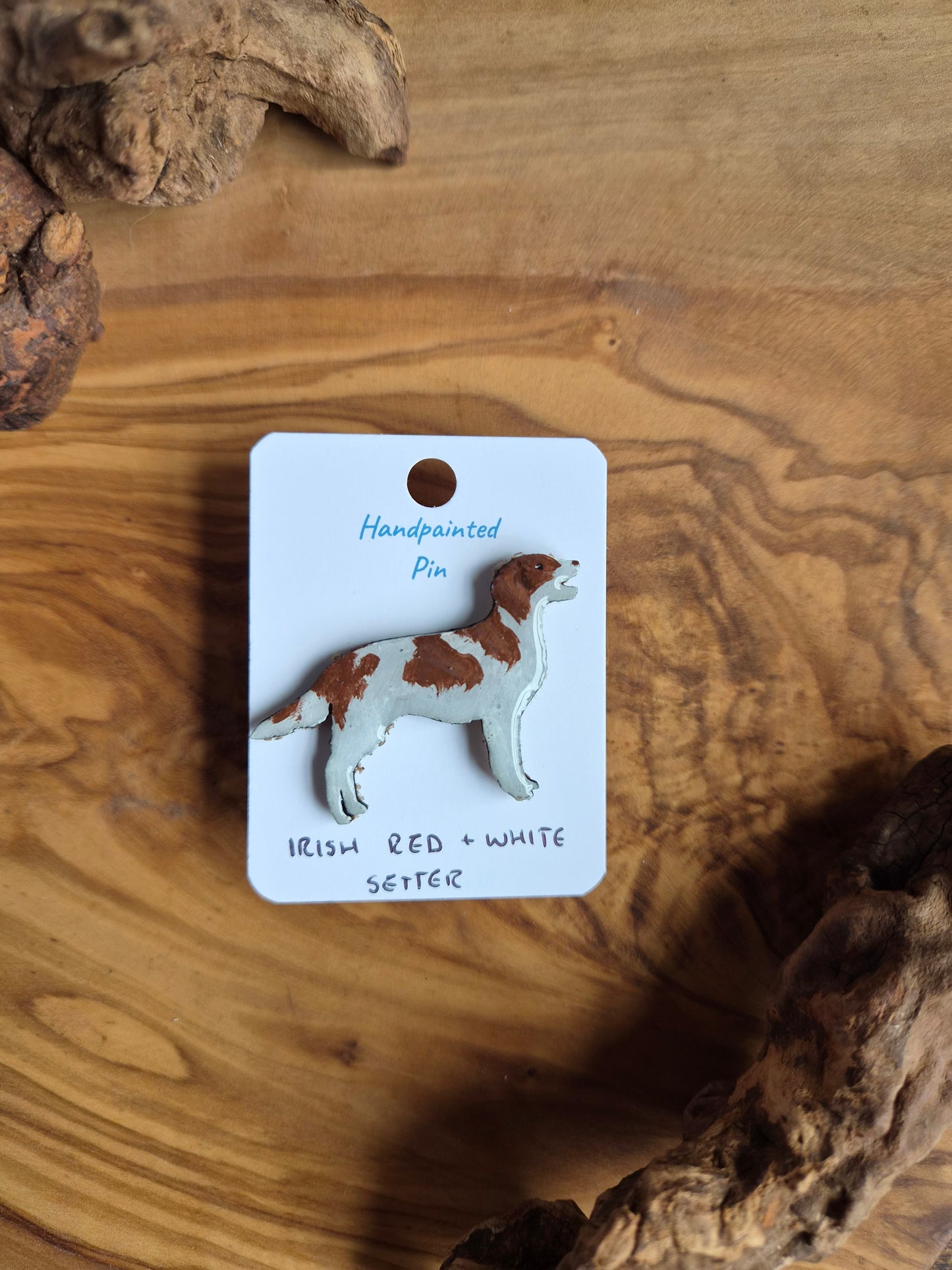 Hand-painted red and white Irish Setter shaped dog pin badge, painted onto wood.