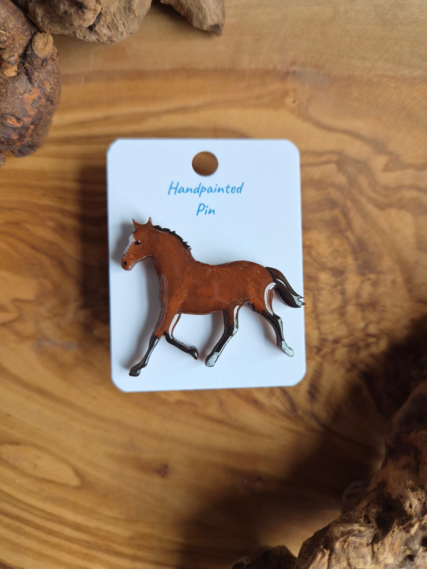 Hand-painted horse shaped wooden pin badge.  Cherry bay colour with 2 white socks and a blaze