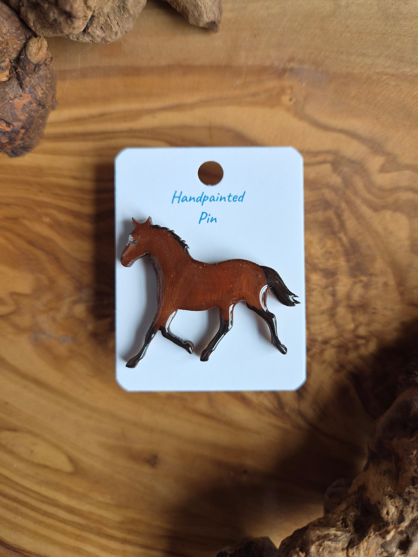 Hand-painted horse shaped wooden pin badge.  Cherry bay with a white star colour