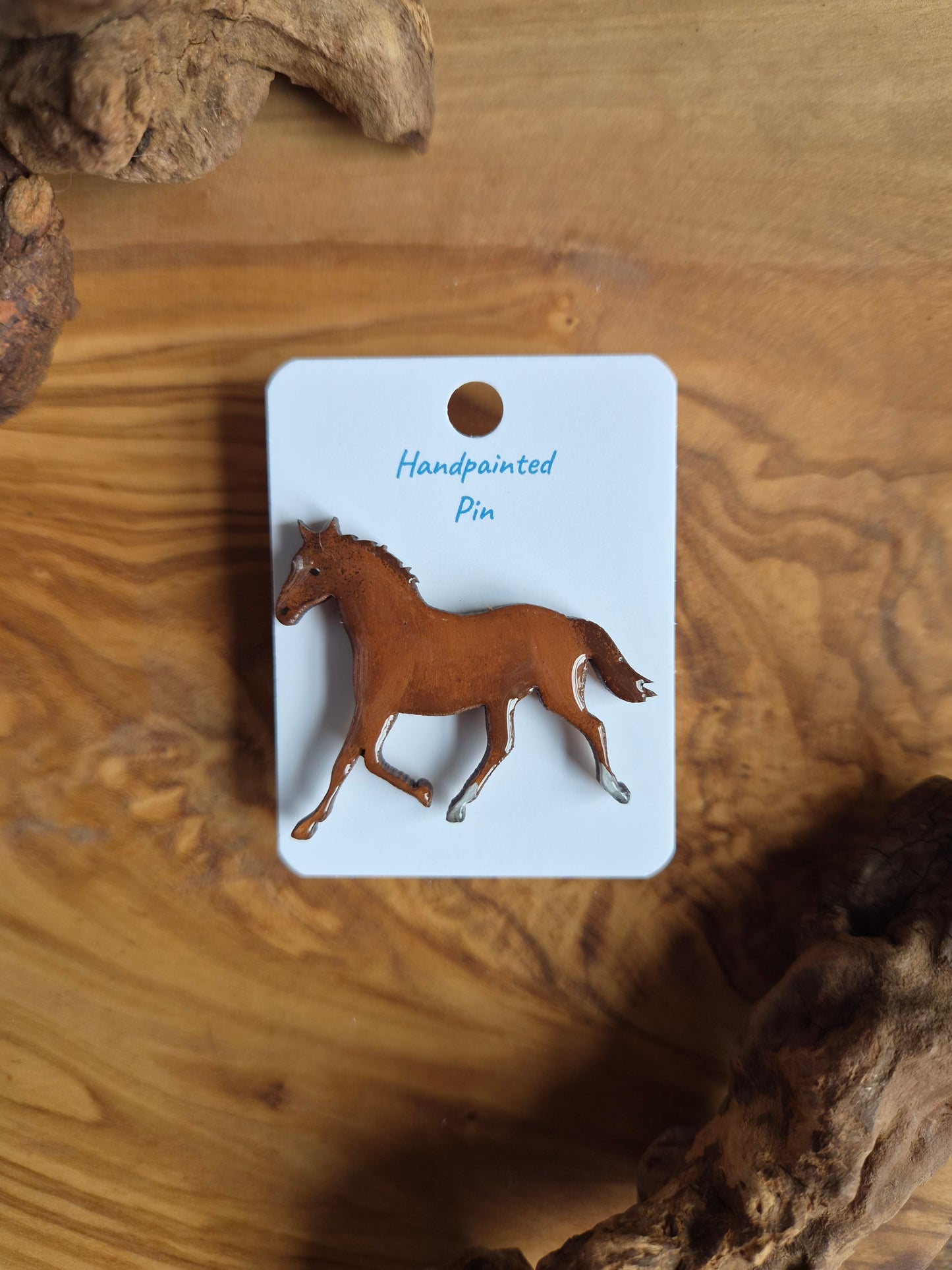 Hand-painted horse shaped wooden pin badge.  Chestnut with 2 white socks and a star colour